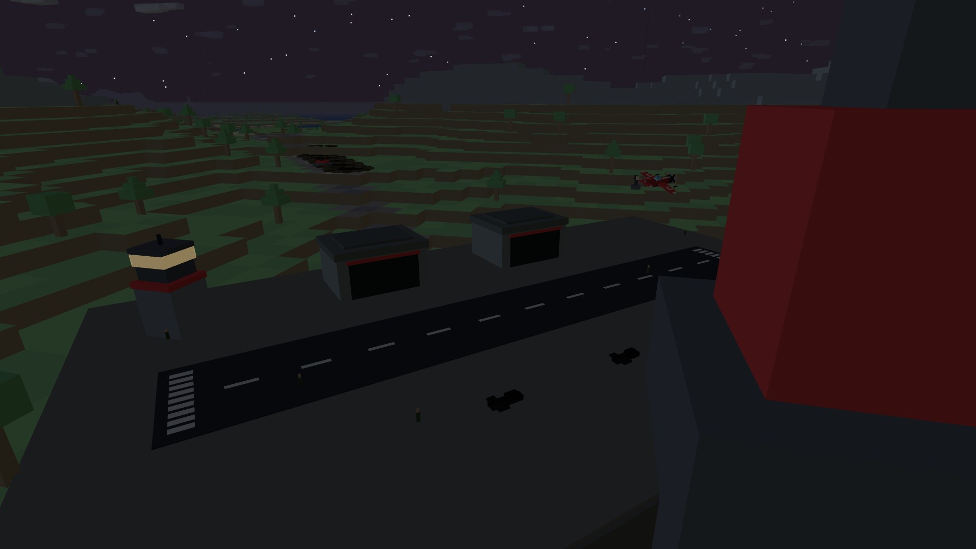 An airfield at dusk: a control tower with a lit amber window band, two hangars, and a marked runway on a graded apron, a fighter passing low overhead under a star-flecked sky